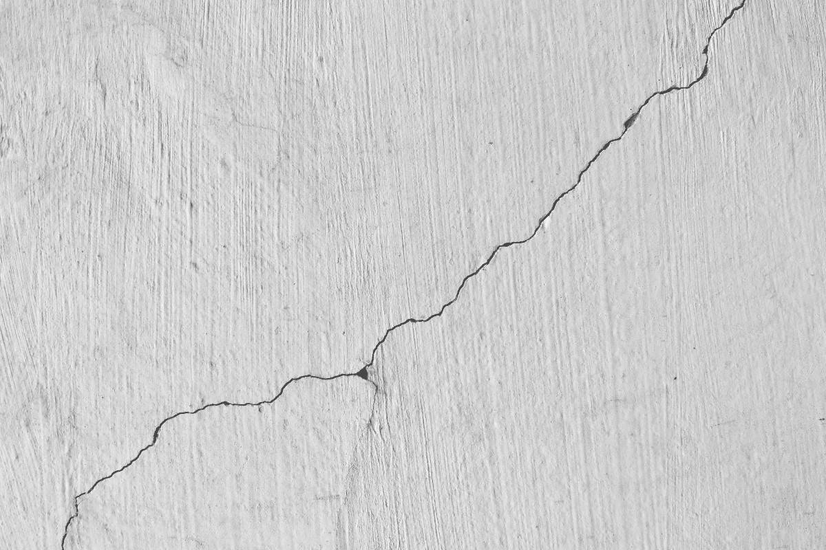 Why do walls in a new apartment or house crack?